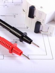 Cables of multimeter and electric fuse on construction drawing