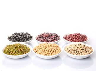 Fototapeta premium Beans variety in white bowl over white background