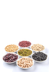 Beans variety in white bowl over white background