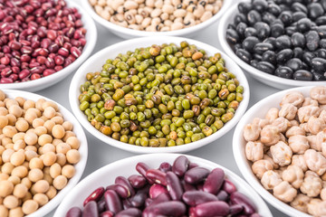 Beans variety in white bowl over white background