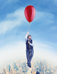 Fototapeta na wymiar Businessman flying on the big ballon