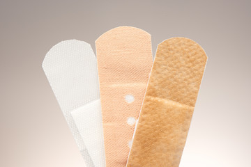 Set of three medical adhesive plasters with different purposes