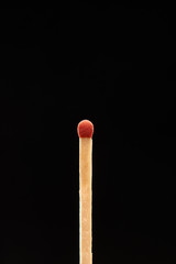 Red match isolated on black background