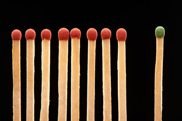 Set of eight red and one green wooden matches
