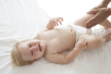 Fototapeta na wymiar baby crying on white bed