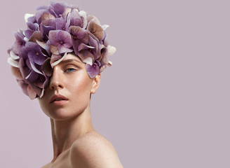 beauty woman watching flowers on her head - 85453282