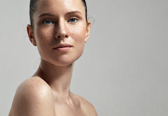 freckles woman's face portrait with healthy skin.. - obrazy, fototapety, plakaty