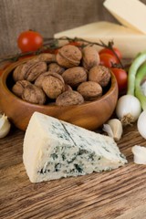 Big portion of niva cheese in front of various vegetable