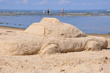Sandcastle police on a beach, concept of protection and security
