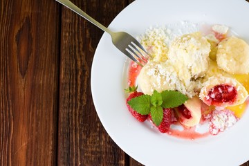 Top view on white plate with fruit dumplings