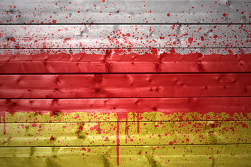 painted south ossetia flag on a wooden texture