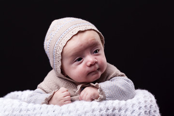 Portrait of a newborn baby boy on black background