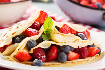 Delicious pancakes with raspberries, blueberries and strawberrie