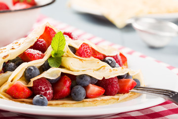 Delicious pancakes with raspberries, blueberries and strawberrie