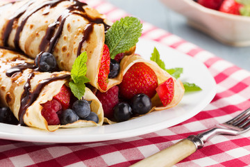 Delicious pancakes with raspberries, blueberries and strawberrie