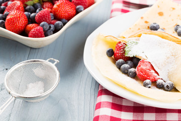 Delicious pancakes with raspberries, blueberries and strawberrie
