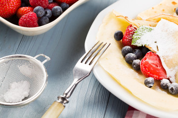 Delicious pancakes with raspberries, blueberries and strawberrie