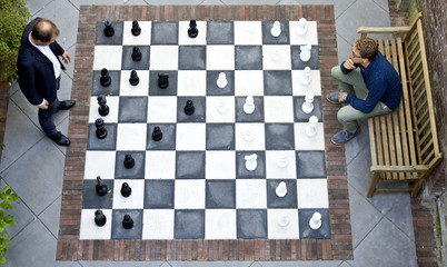 Two men playing a game of outdoor chess