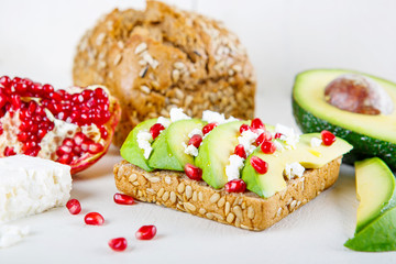 Avocado with Feta, pomegranate on sunflower seeds bread sandwich