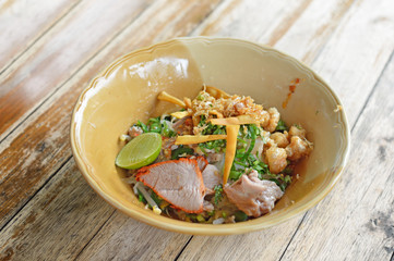 Delicious rice noodles with pork close-up on a plate