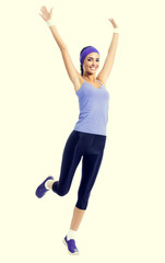 happy smiling woman jumping or doing fitness aerobics exercise