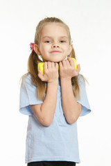 The girl hugged her in the hands of a dumbbell