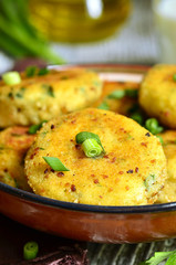 Homemade potato patties with herbs and green onion.