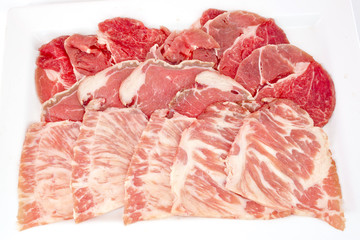 Assorted Fresh Cured Meats on white dish isolate