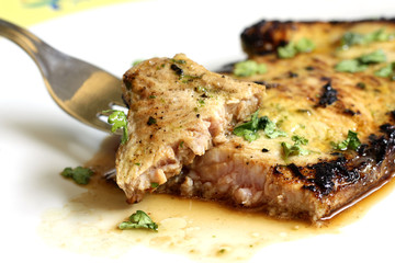 served delicious piece of tuna steak with greenery
