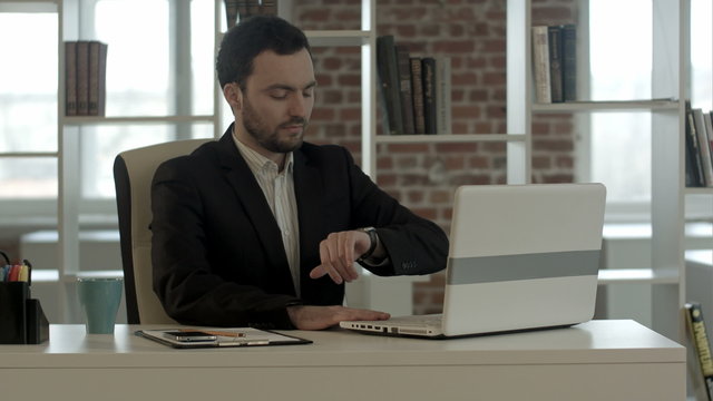 Businessman with notebook in office finished work, close laptop