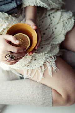 Cup of tea in hand of girl. Soft focus