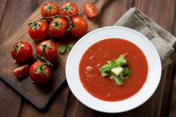 Gazpacho cream-soup with cucumber and basil topping, studio shot
