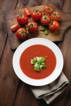 Tomato soup gazpacho over dark rustic wooden background