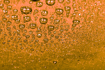 Drops of water on a color background. Orange. Shallow depth of f