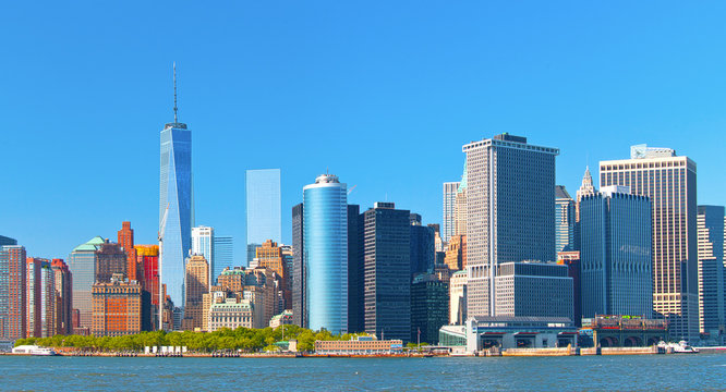 New York City lower Manhattan financial  wall street district buildings skyline on a beautiful summer day with blue sky
