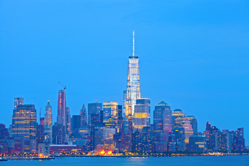 Fototapeta premium New York City skyline of financial business buildings in Manhattan illuminated at sunset