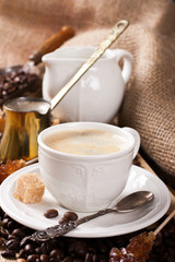 Old coffee pot and cup on wooden rustic background