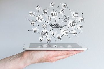 Cloud computing and mobile computing concept. Hand holding tablet or smart phone