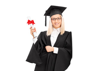 Female college graduate holding a diploma and leaning against a