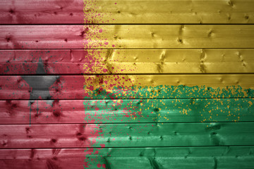 painted guinea bissau flag on a wooden texture