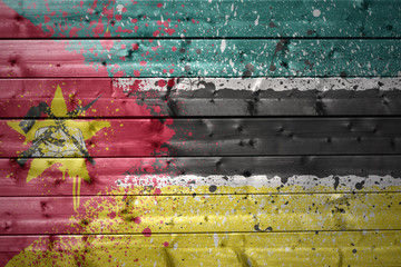 painted mozambican flag on a wooden texture