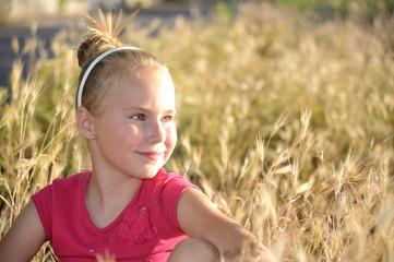 Portrait of little girl in nature.Side view, looking something 