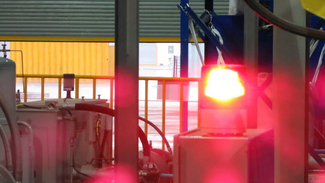 Red light on machine in factory