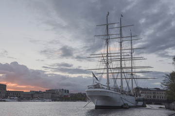 Fototapeta na wymiar Historical ship with sunset sky at the Old Town in Stockholm, Sweden