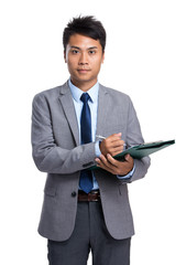 Businessman write on clipboard