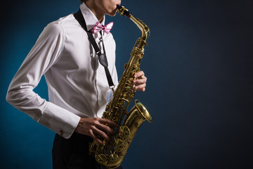 Fototapeta na wymiar A man plays the saxophone close up.