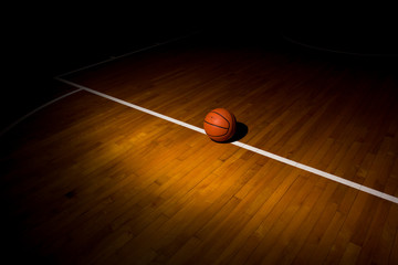 Naklejka premium Basketball ball over floor in the gym