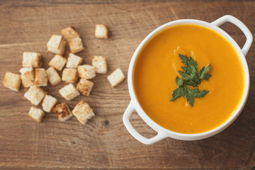 carrot soup with crackers on the wood table