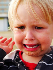 girl with sand in face and eye