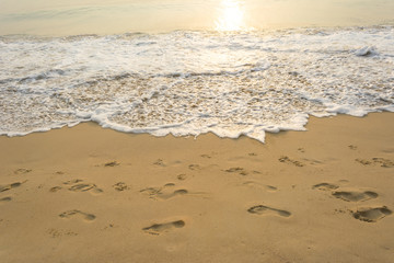 Sea wave and many foot print  on the beach background